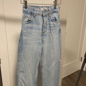 Straight light blue jeans with special hem